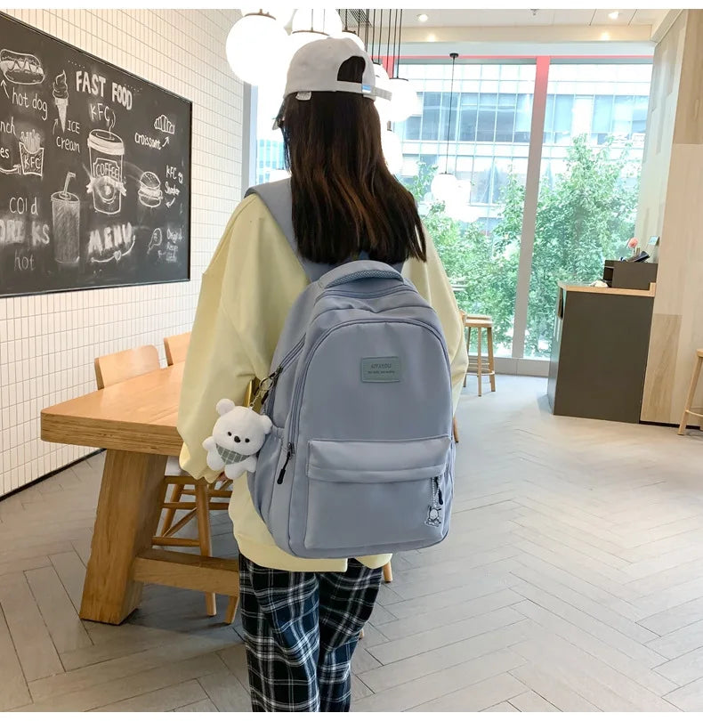 Student Japanese large-capacity backpack Girl simple and versatile backpack Unisex polyester material Doll decoration