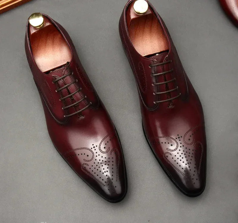Pair of maroon dress shoes with gold accents on a gray background, featuring the AST Astonm jazz brand.