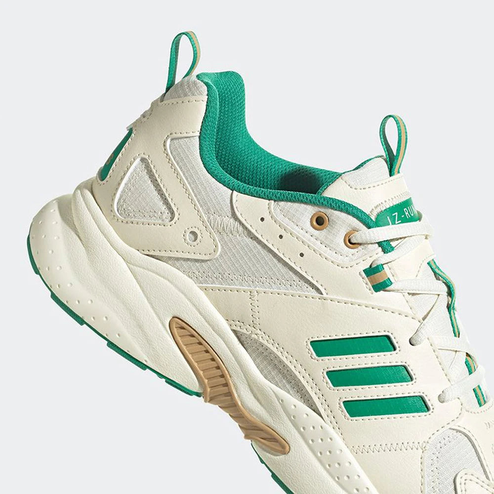 Beige and green sneaker with a white background