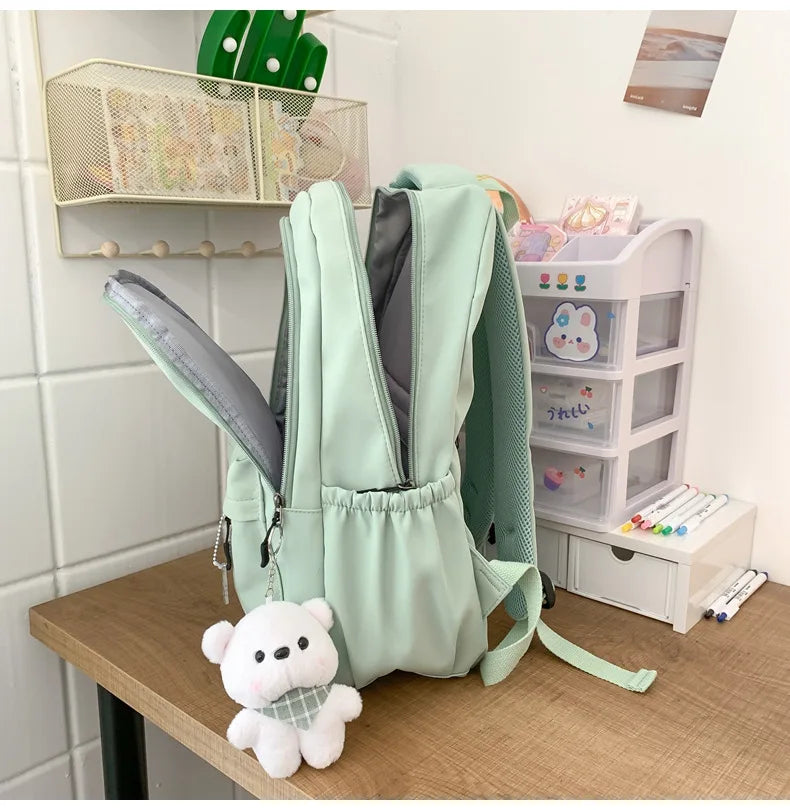 Student Japanese large-capacity backpack Girl simple and versatile backpack Unisex polyester material Doll decoration