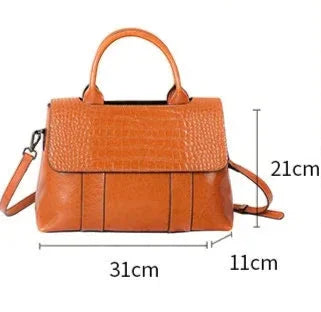 Brown leather handbag with measurements and details on a white background