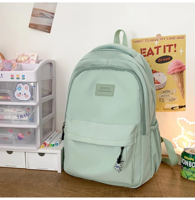 Student Japanese large-capacity backpack Girl simple and versatile backpack Unisex polyester material Doll decoration