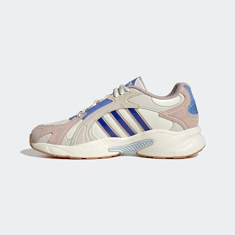 Beige and blue Adidas sneaker on a light gray background