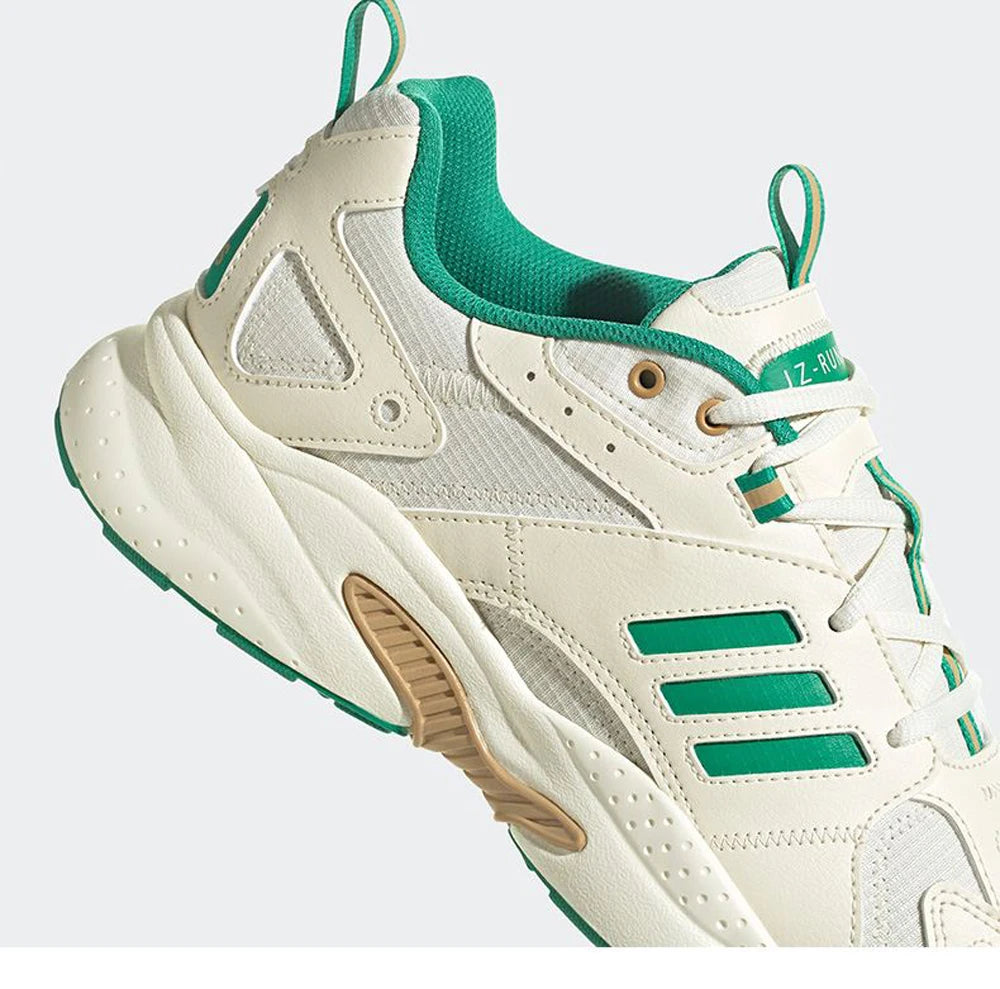 Beige and green sneaker with white sole on a light gray background