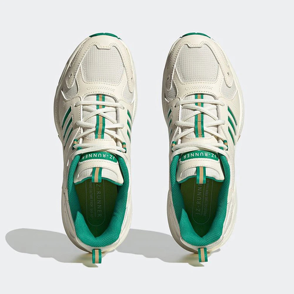 White and green sneakers on a light gray background
