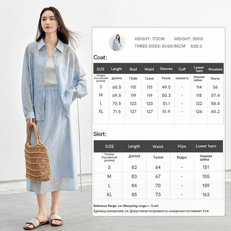 Woman wearing a light blue coat and skirt with size chart on a white background