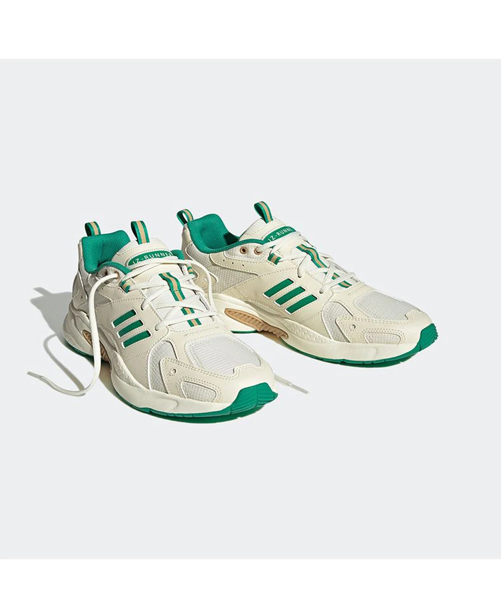 White sneakers with green accents on a white background