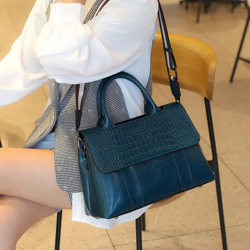 Person holding a blue handbag in an indoor setting