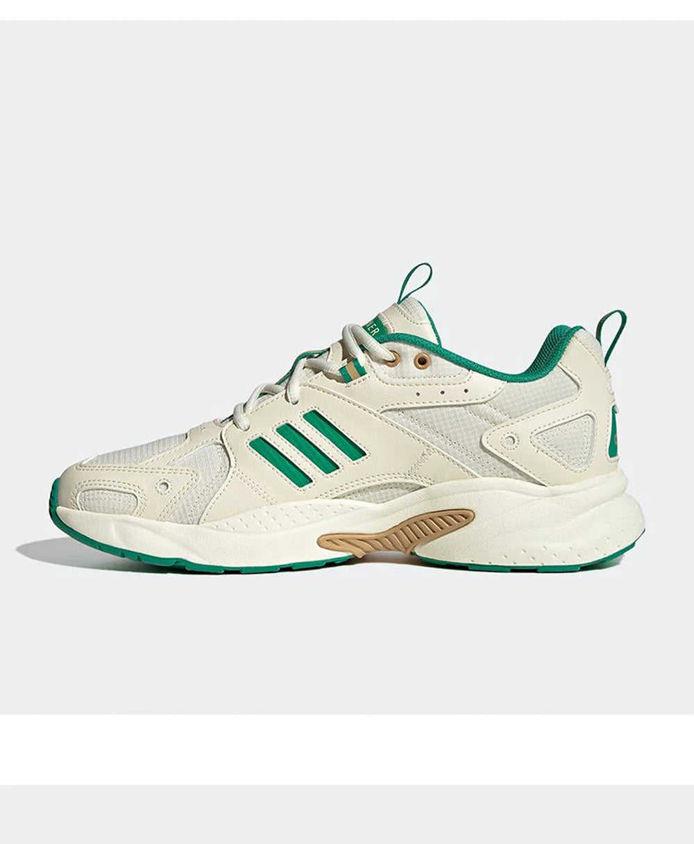 Beige and green sneaker with Adidas logo on a white background