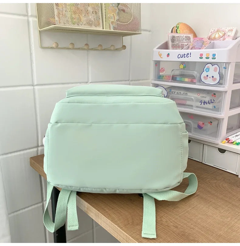 Student Japanese large-capacity backpack Girl simple and versatile backpack Unisex polyester material Doll decoration