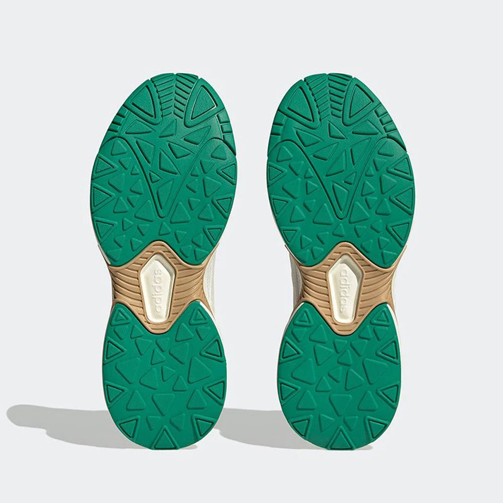 Green and beige shoe soles on a light gray background
