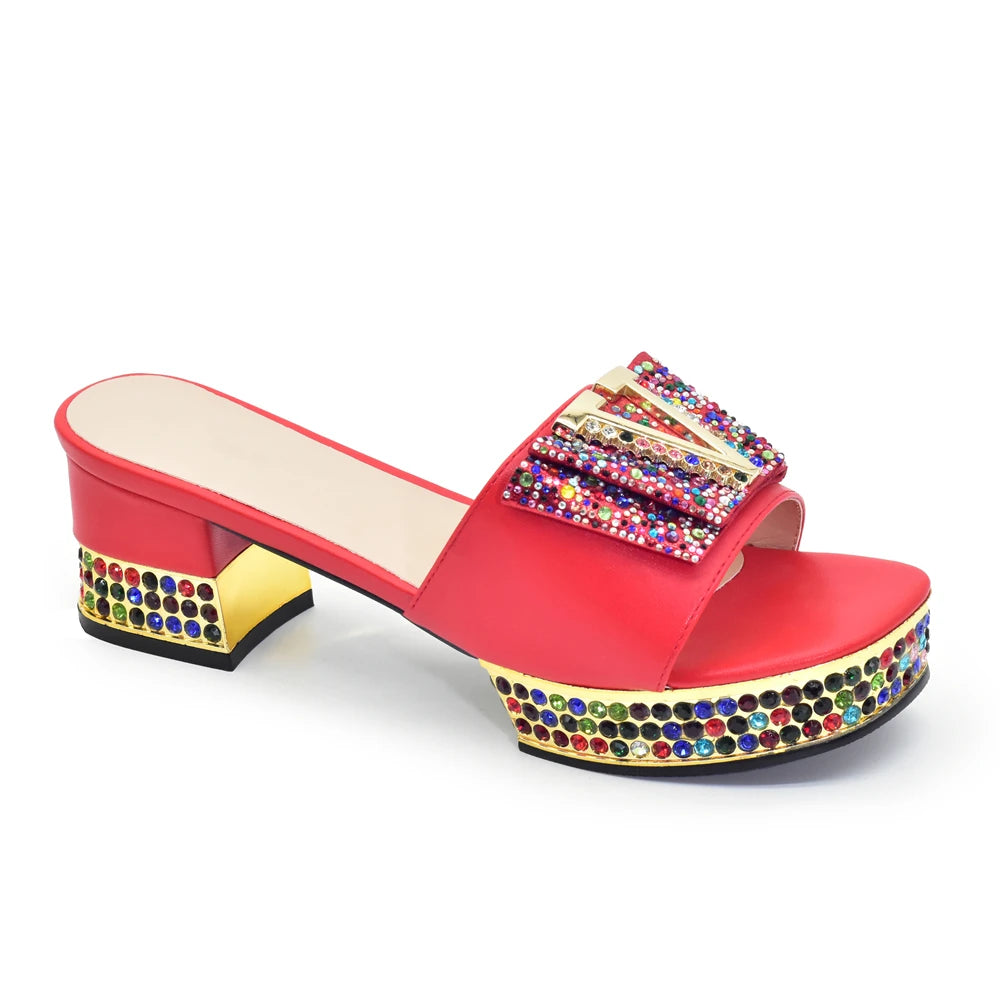 Red sandal with multicolored embellishments on a white background