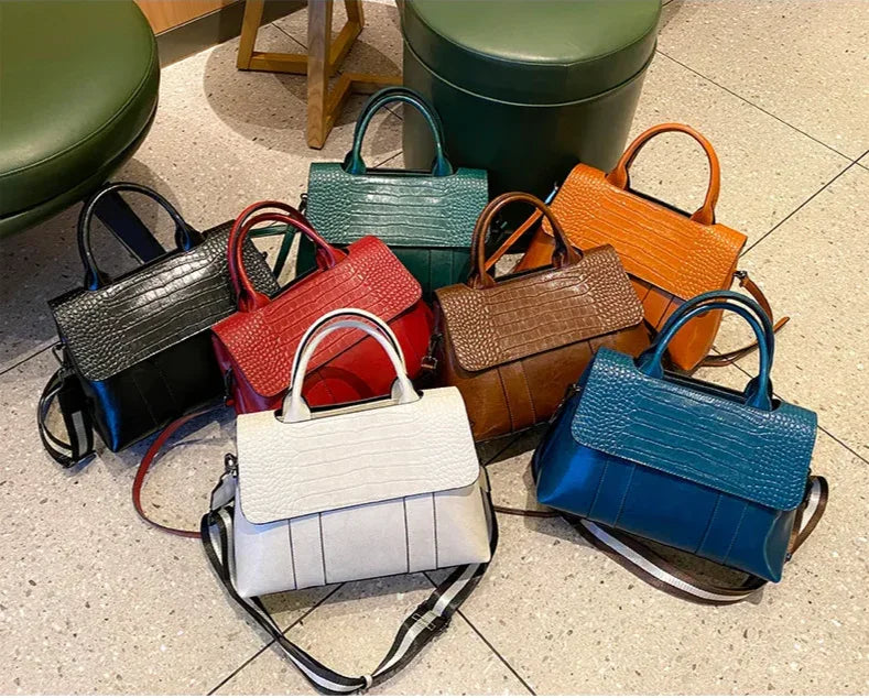 Collection of colorful handbags on a tiled floor