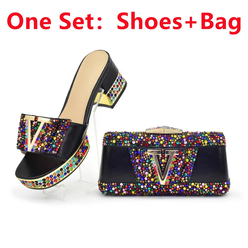Black shoe and bag set with colorful embellishments on a white background