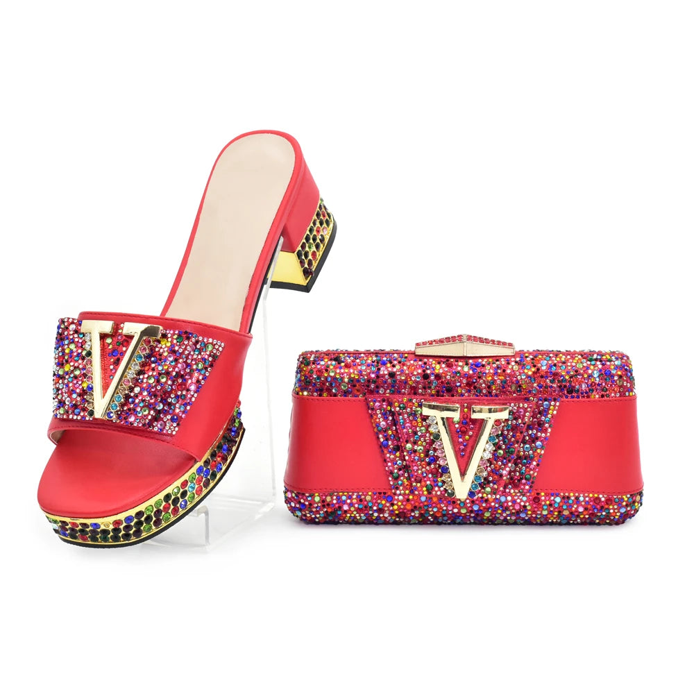 Red high-heeled shoe and matching handbag with multicolored embellishments on a white background