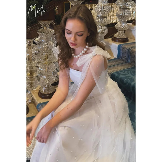 فساتين سهرة بيضاء مُخصصة من Mila Bow Straps بدون أكمام وأربطة لحفلات التخرج 2025 من التول بطول متوسط لحفلات الزفاف الرسمية