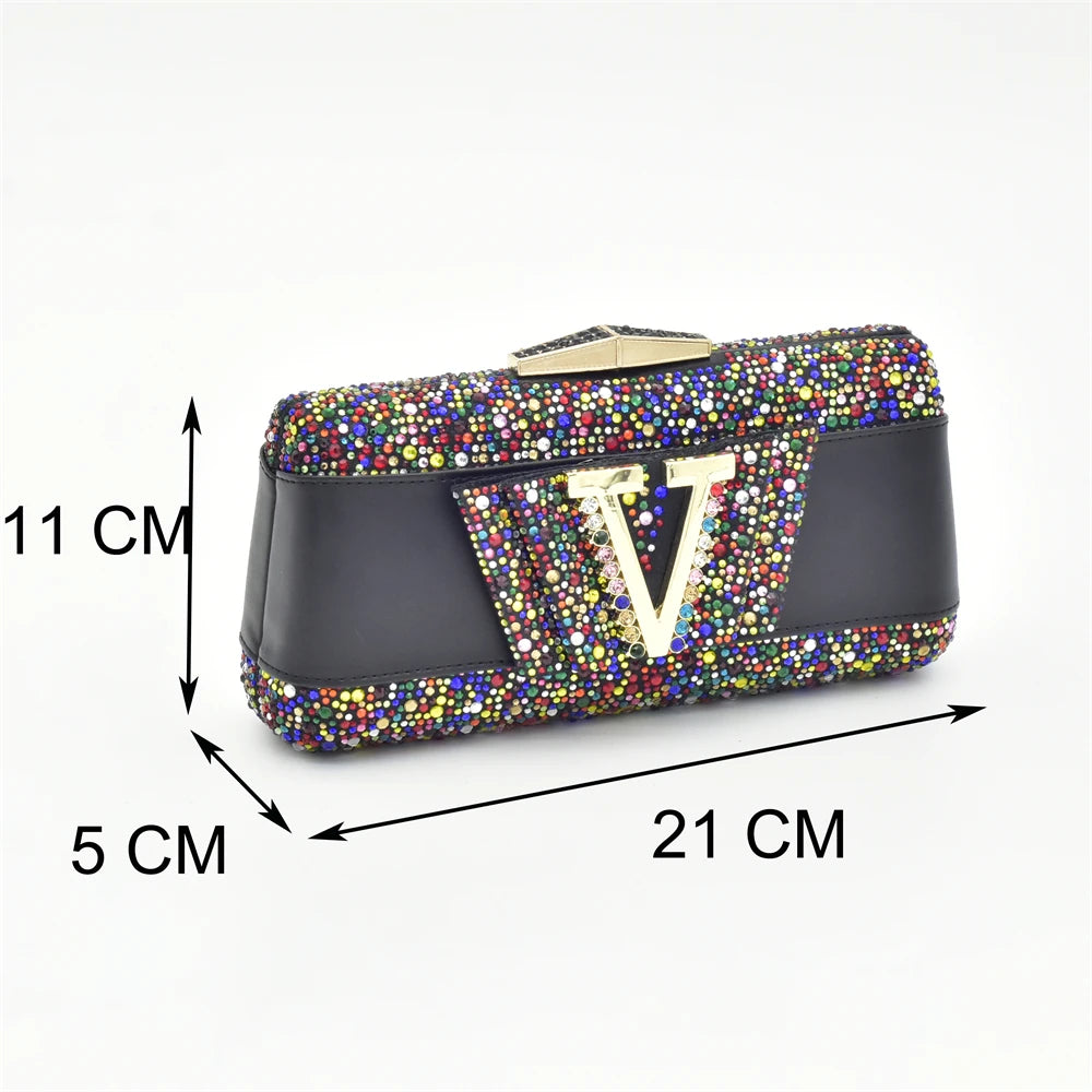 Black clutch bag with colorful gemstones and measurements on a white background