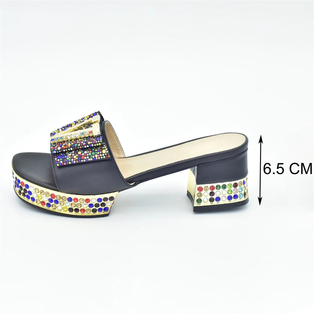 Black sandal with colorful embellishments on a white background