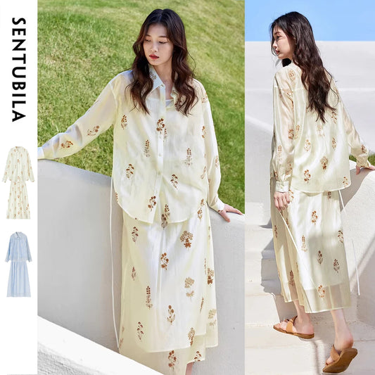 Woman wearing a light-colored floral dress with Sentubila branding.