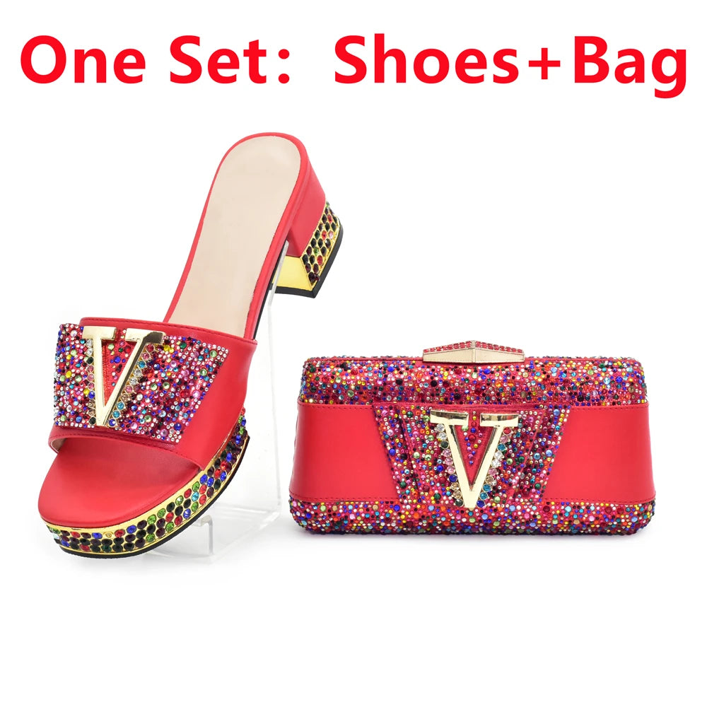 Red shoe and matching bag set with multicolored embellishments on a white background