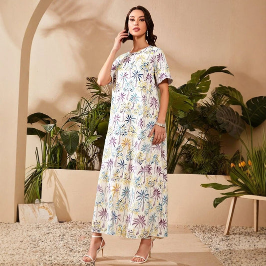 Woman wearing a floral dress standing in a decorative setting with plants.