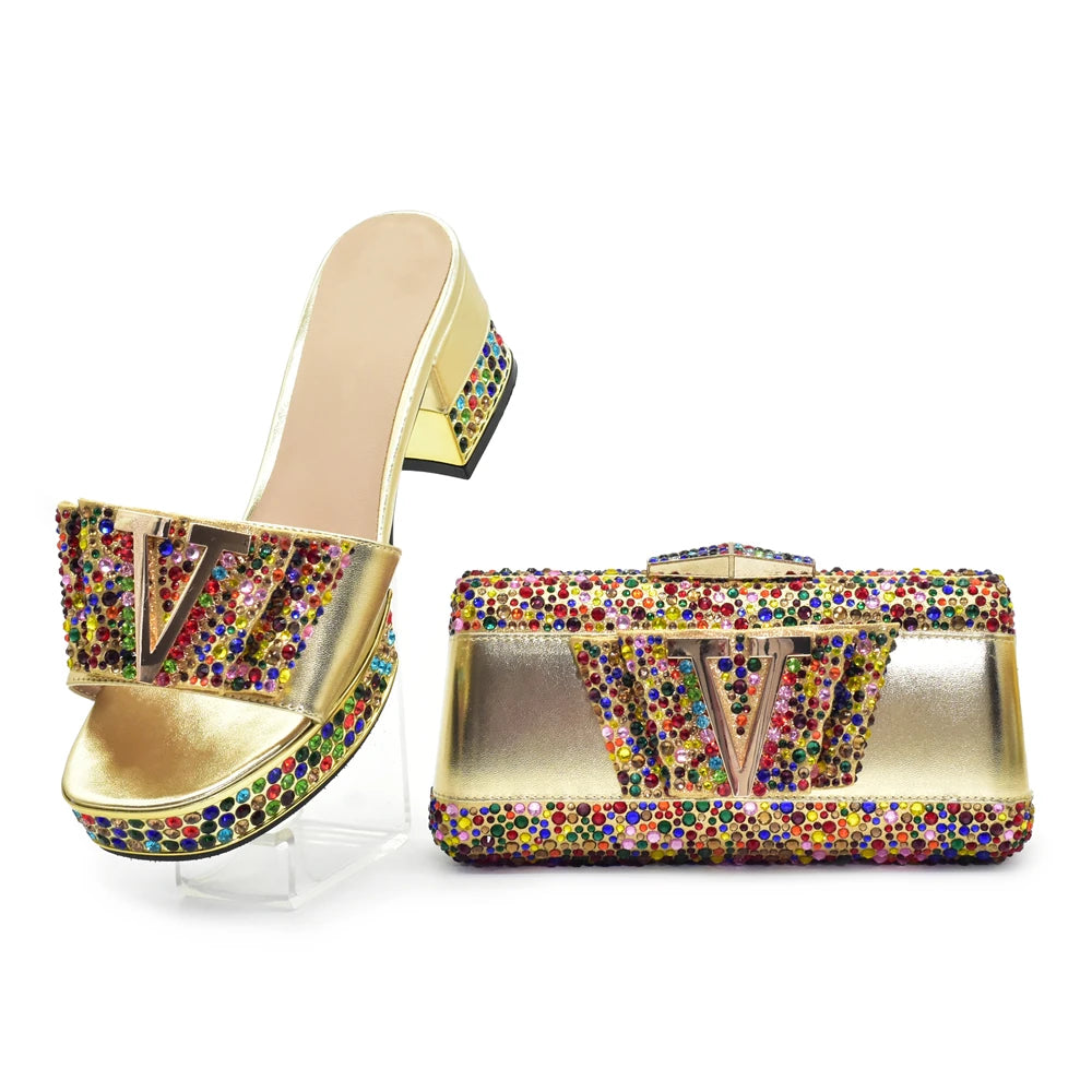 Gold high-heeled shoes with colorful gemstones on a white background