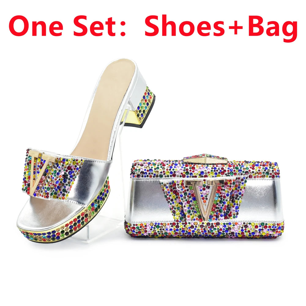 Shiny high-heeled shoes with colorful embellishments and matching handbag on a white background.