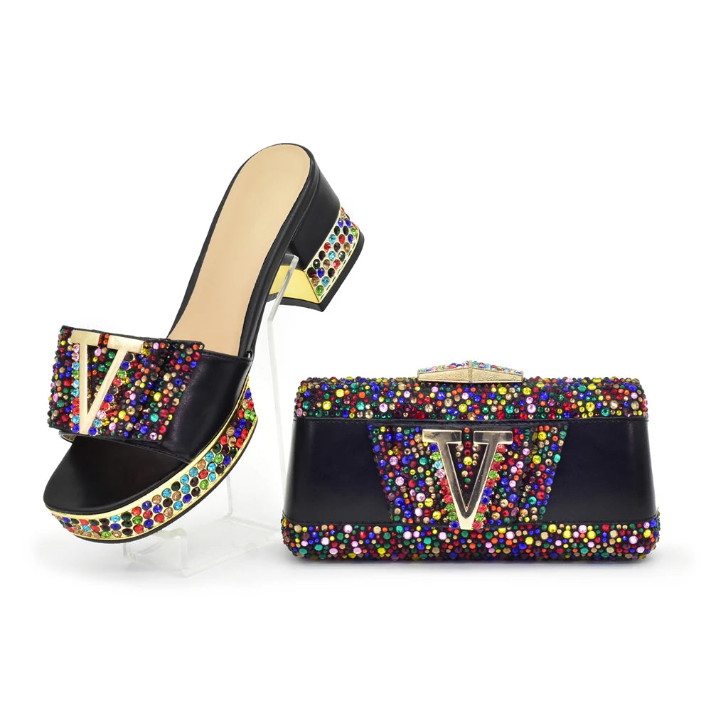 Black high-heeled shoe with colorful embellishments and matching bag on a white background