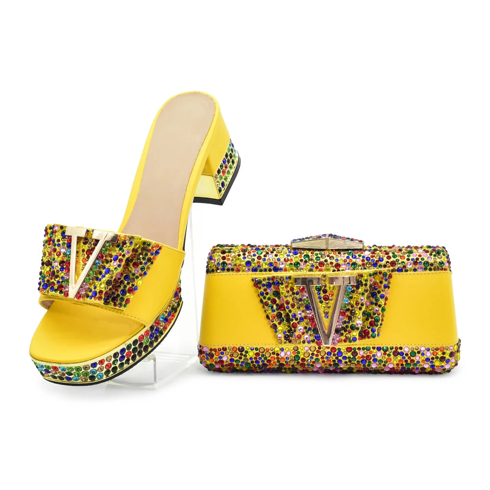 Yellow high-heeled shoe and matching handbag with colorful embellishments on a white background